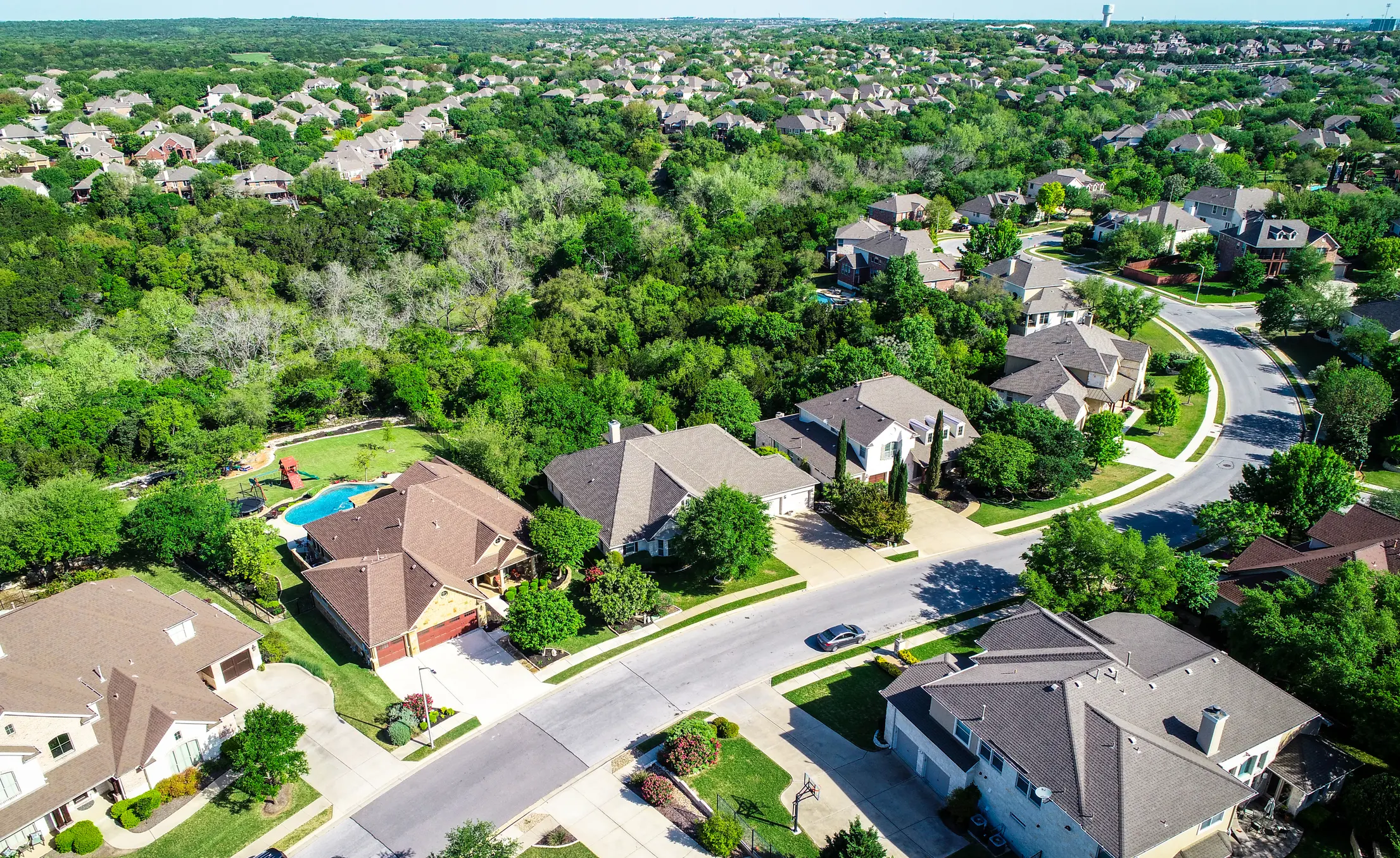Aerial view of suburban homes along curved street