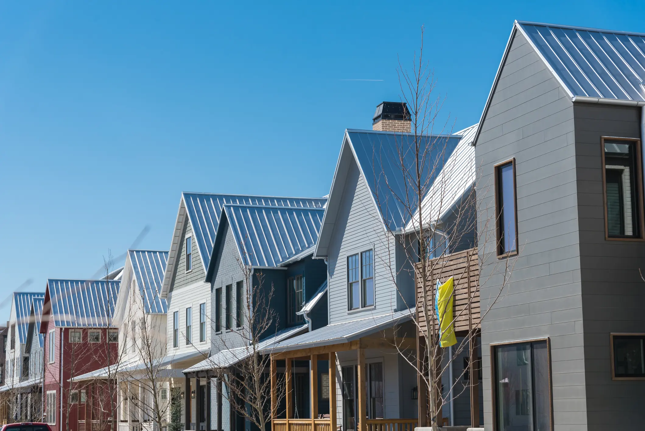 Row of modern houses with metal roofs